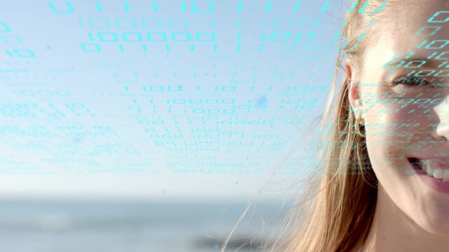 Adult woman smiling and shifting head while cyan code overlay appearing across face, promoting tech