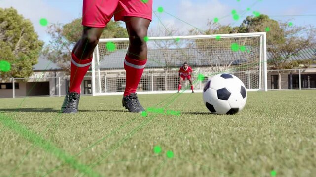Soccer player standing over ball, performing stepovers to mislead goalkeeper, HUD dots linking feet