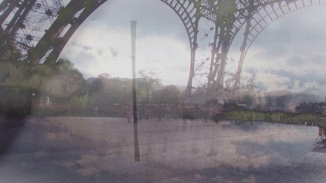 Cloud overlay drifting, iron arch framing plaza while visitors shifting and clustering for viewing