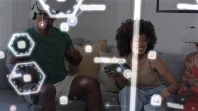 Center woman tapping tablet, coordinating tech HUD hexagons while friends wearing VR headset react