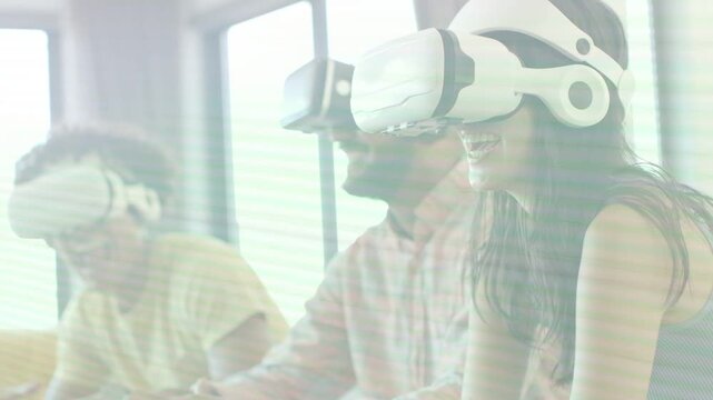 Three adults wearing VR headsets after starting demo gesturing more while animated UI reacting