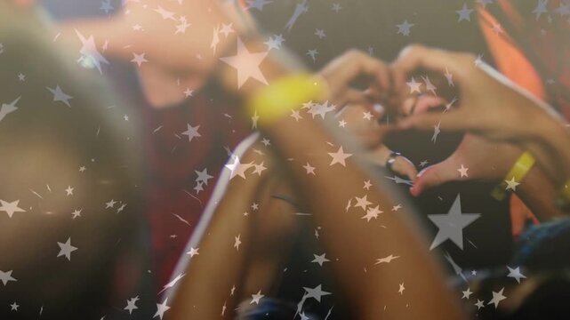 Crowd forming hearts as chorus hits, star overlay hovering above crowd and wristbands showing love