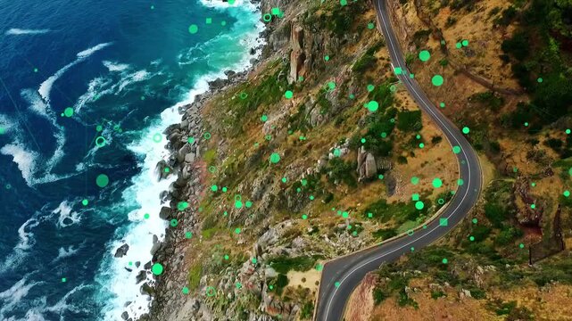 Oblique cam starting drift, cliff road revealing more shore; green graphics shifting over sea, land