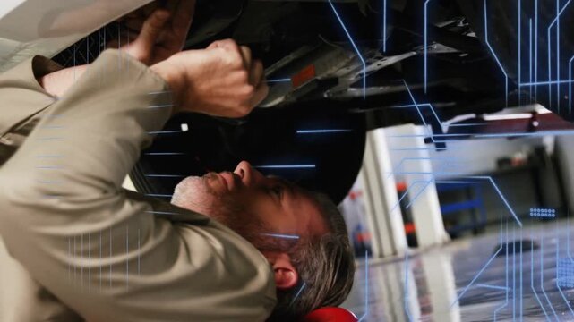 Automotive tech on red creeper reaching under vehicle, AR overlay appearing and guiding repair
