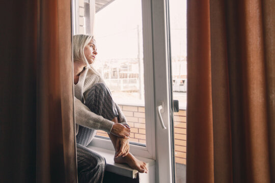Sad pensive adult 40s woman at home
