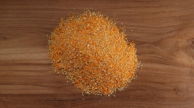 Top View of Finely Ground Corn for Poultry Feed on Wooden Background