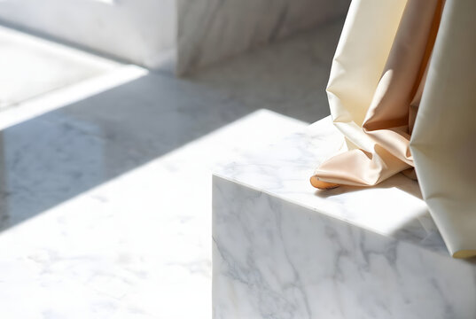 Luxury white marble podium with draped silk fabric for premium product display and branding