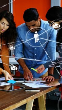Vertical video: Phone ringing designers planning layouts, placing sticky notes, showing network map