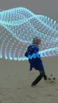 Vertical video: Boy walking across sandy beach with animated blue wave guiding movement for tech