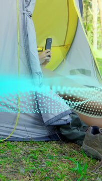 Vertical video: Turquoise wave appearing camper reclining with phone adjusting legs showing network