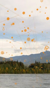 Vertical video: Orange overlay starting over shore, particles drifting and linking to accent forest