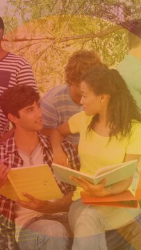 Vertical video: Pair studying with yellow notebook and teal book, orange overlay shifting colors