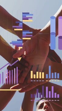 Vertical video: Arms entering, biz team stacking hands and interlocking, charts overlaying, uniting