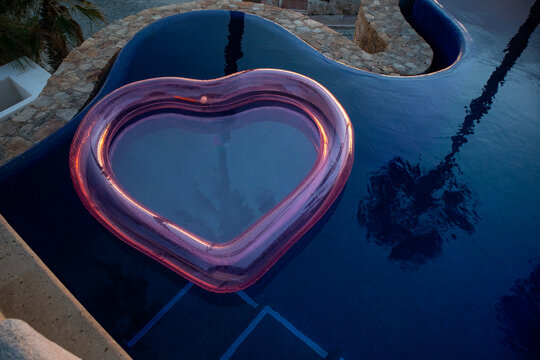 Heart-shaped pool float in a serene luxury resort swimming pool