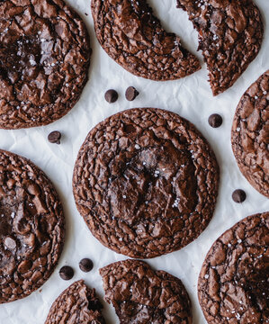 Top view close up of many chocolate brownie cookies on parchment.