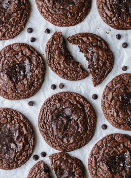 Overhead view freshly baked chocolate brownie cookies on parchment.