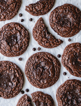 Overhead view freshly baked chocolate brownie cookies on parchment.