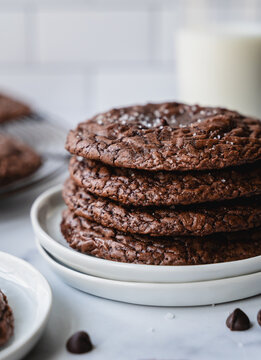 Close up of stack of chocolate brownie cookies and milk.