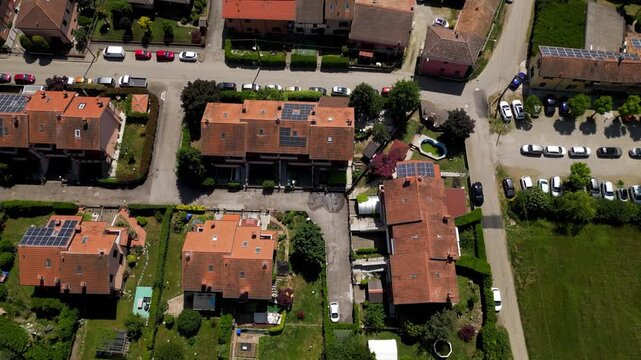 Aerial View of Residential District: An expansive aerial perspective showcases a meticulously planned residential district. Houses with red tiled roofs and well-maintained green spaces.