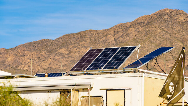 Caravan with tilt solar panels on roof on mediterranean coast