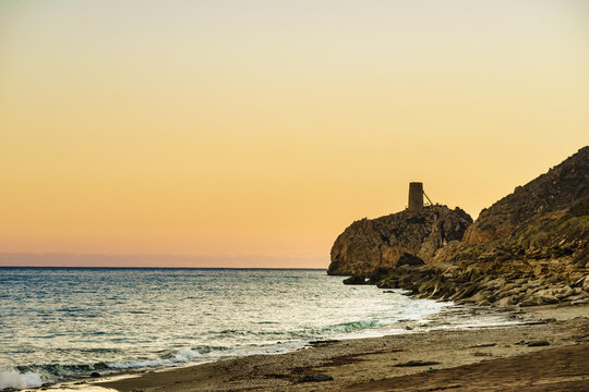 Pirulico tower historical landmark on a rocky outcrop next to the sea in Almeria Spain
