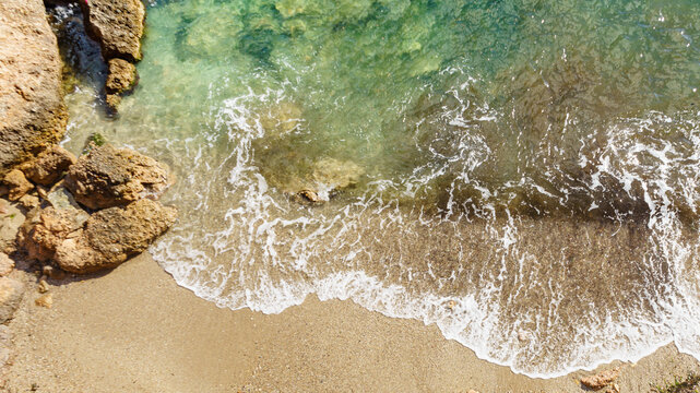 Aerial view. Sea waves and sandy beach