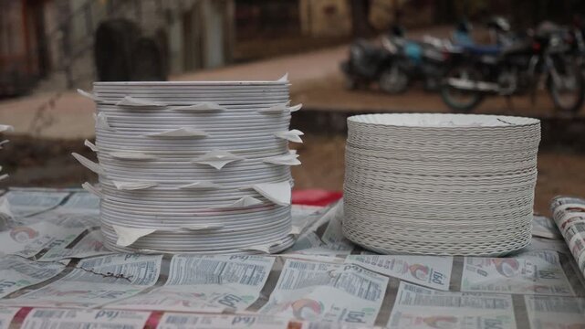 Raw 4K footage of ceramic plates stacked and arranged for a marriage function, showing catering preparation, traditional serving setup, and event organization in India.