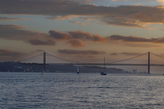 Sunset over the Ponte 25 de Abril, bridge over the river Tejo in Lisbon, Portugal.