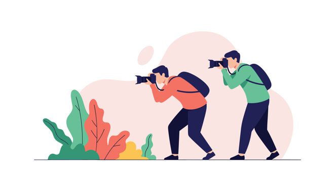 Two professional photographers in orange and green shirts with backpacks crouching down to capture photos of colorful plants in nature.