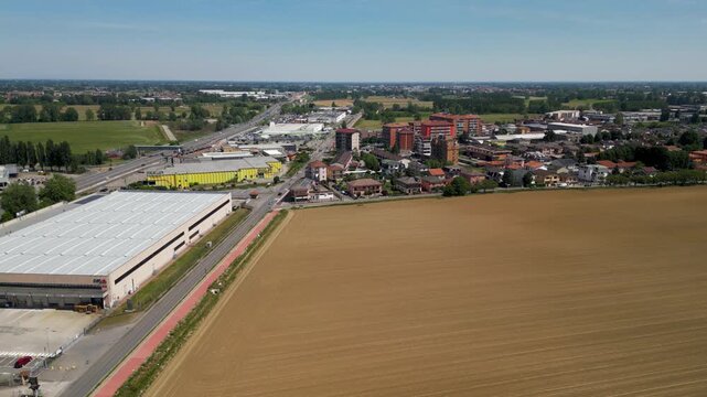 Cityscape and Industrial Harmony: An expansive aerial view showcases a vibrant cityscape seamlessly integrated with industrial structures and agricultural expanse.