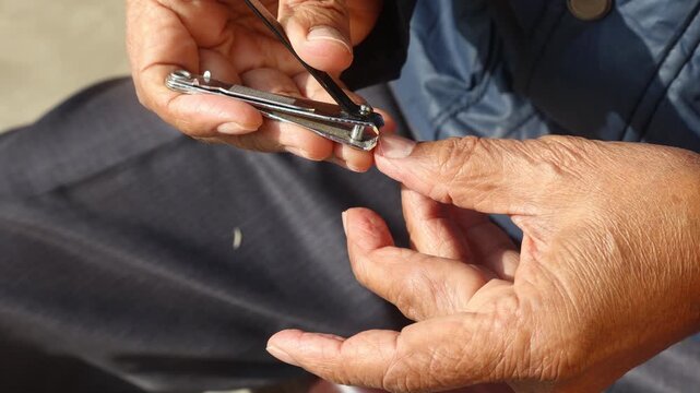 Raw 4K footage of cutting fingernails using a nail cutter, showing personal hygiene, grooming routine, and simple daily self care activity in a close-up setting.