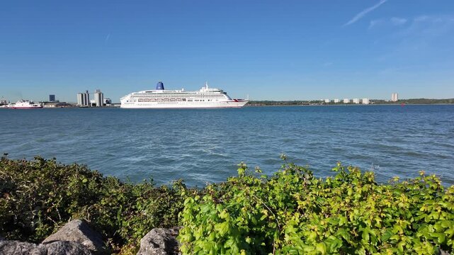 Southampton England UK. 28.04.2026. Video. Viewed from Hythe Hampshire a white cruise ship outbound from the port of Southampton UK