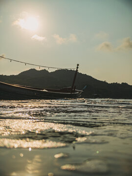 Serene seaside scene. Calm vessel anchored near sunlit sands