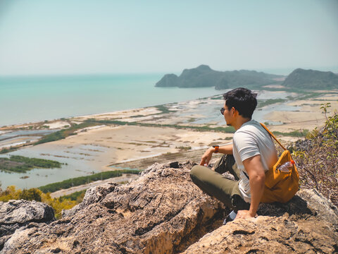 Peaceful scene with man contemplating saltpans and distant islands