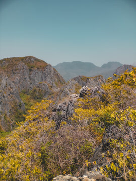 Serene vista of rugged rocks and distant mountain peaks