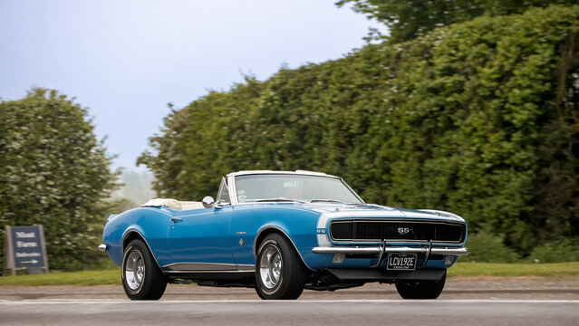 Bicester,Oxon.,UK - Apr 26th 2026:  1967 blue Chevrolet Camaro American  car driving on a British road