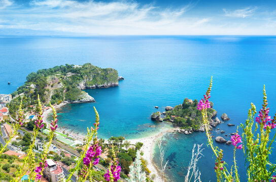 Isola Bella and Mazzaro Bay in Taormina Sicily at sunny summer day. Aerial view of turquoise Mediterranean sea, rocky cliffs and pebble beach. Welcome to Taormina concept