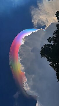low angle shot of rare iridescent pileus cloud with vibrant rainbow colors effect