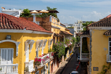 Yellow building on a street with colonial architecture in the Old Town, Cartagena, Colombia