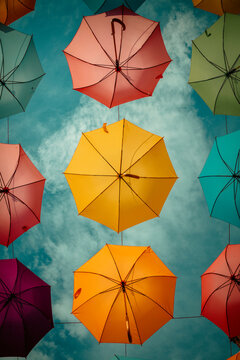 Novigrad, Croatia, 20th August 2025, colourful umbrellas hung up in the street against a Mediterranean blue sky