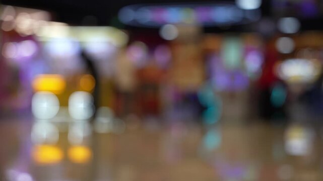 Blurred view of amusement arcade game center, toy crane game vending machine