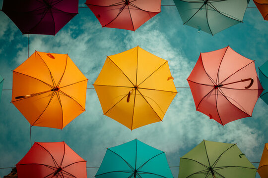Novigrad, Croatia, 20th August 2025, colourful umbrellas hung up in the street against a Mediterranean blue sky