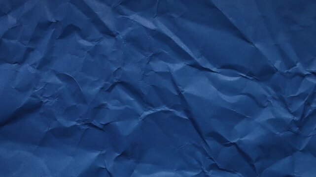 Dark blue wrinkled paper texture seamless loop. Cool stop-motion animation for creative video overlays and modern backgrounds.