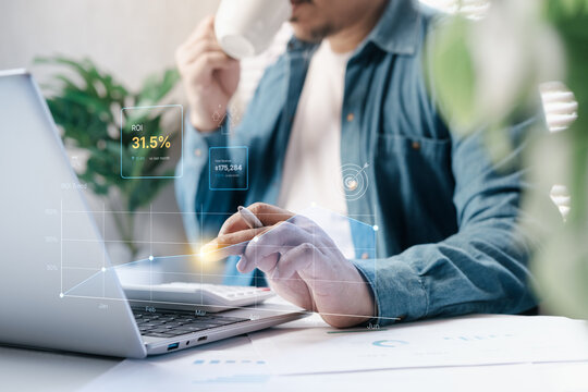 Business professional analyzing ROI growth data on laptop, calculator and coffee, financial performance dashboard overlay showing revenue increase, productivity tracking, data driven decision making