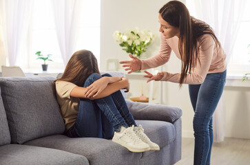 Teenage girl hiding face, mother, teen daughter conflict at home, scolding grown up child, angry...