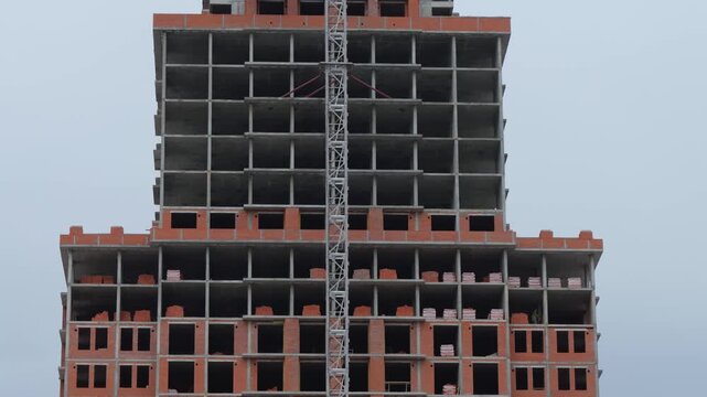 High rise construction site with crane and concrete floors