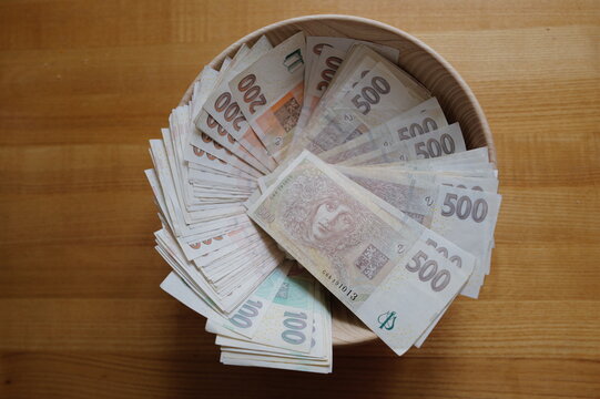 wooden bowl full of paper banknotes