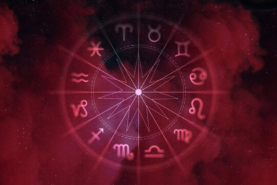 Zodiac signs wheel over a dramatic red nebula and starry sky background. Astrological horoscope, esoteric divination, and mystic magic concept.