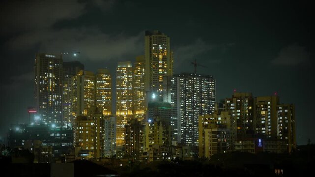 Night timelapse of the Mumbai city skyline, showcasing illuminated skyscrapers, glowing buildings, and continuous traffic movement. The vibrant city lights and dynamic urban atmosphere highlight the e