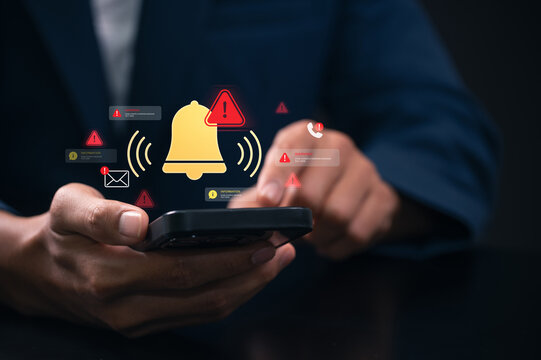Mobile notification alert warning system on smartphone screen with user hand holding device showing push notification message call and security alert interface for communication and user engagement